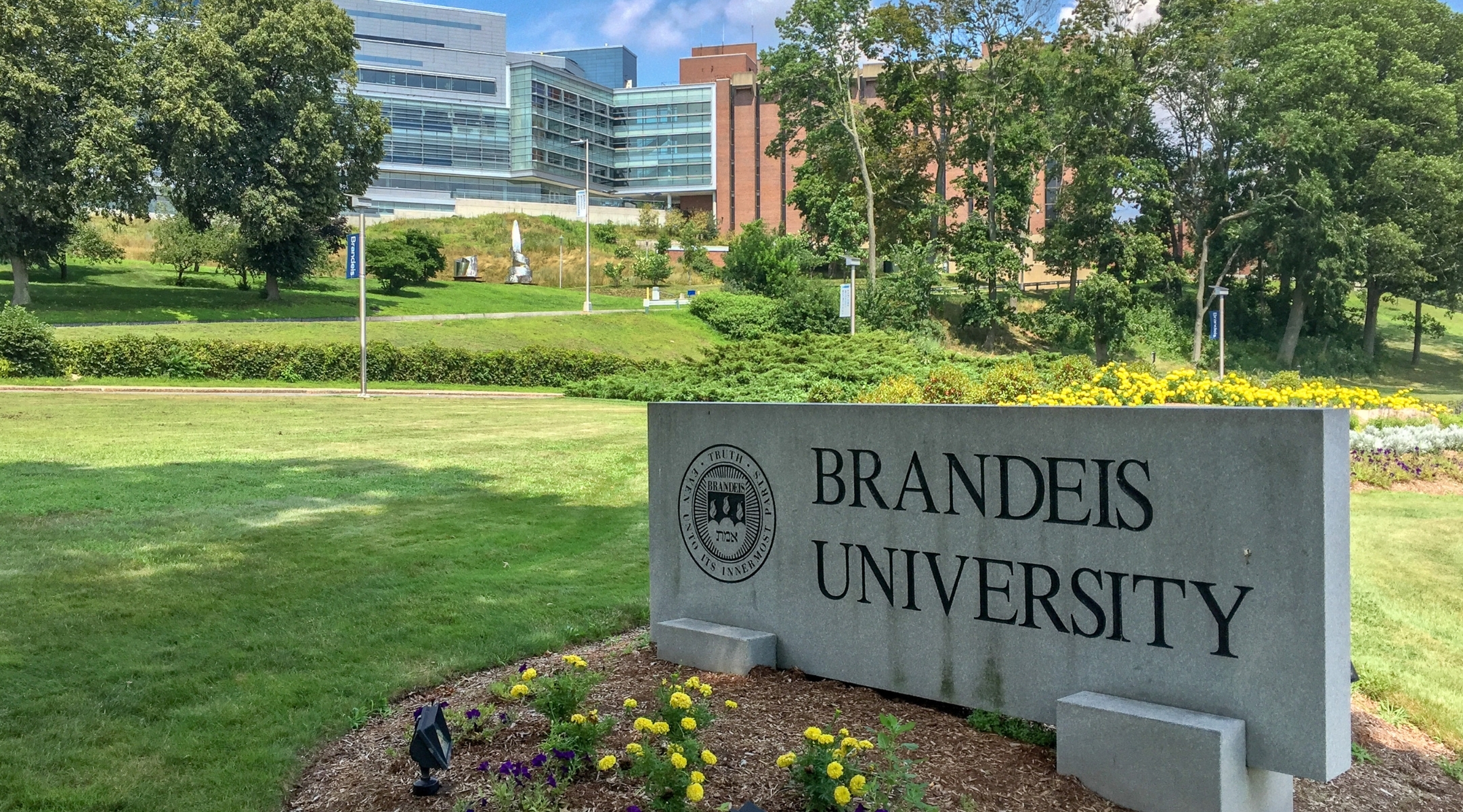 A sign on the Brandeis University campus with the school’s emblem and motto reads, “Truth even unto its innermost parts.” (Wikimedia)