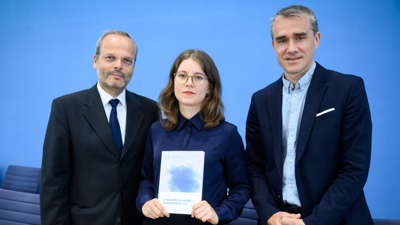 From left to right: Felix Klein, Germany’s antisemitism monitor; Bianca Loy, co-author of the RIAS report; and Benjamin Steinitz, executive director of RIAS, shown in Berlin with the organization’s 2022 antisemitism report, June 27, 2023. (Bernd von Jutrczenka/picture alliance via Getty Images)