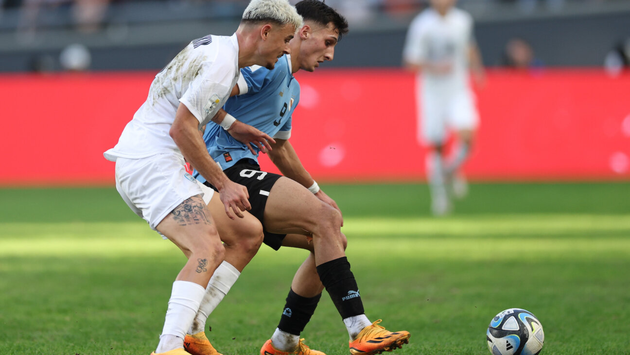 Stav Lemkin of Israel, left, battles for the ball with Andres Ferrari of Uruguay during the FIFA U-20 World Cup semifinal at Estadio La Plata in La Plata, Argentina, June 8, 2023. (Tim Nwachukwu/FIFA via Getty Images)