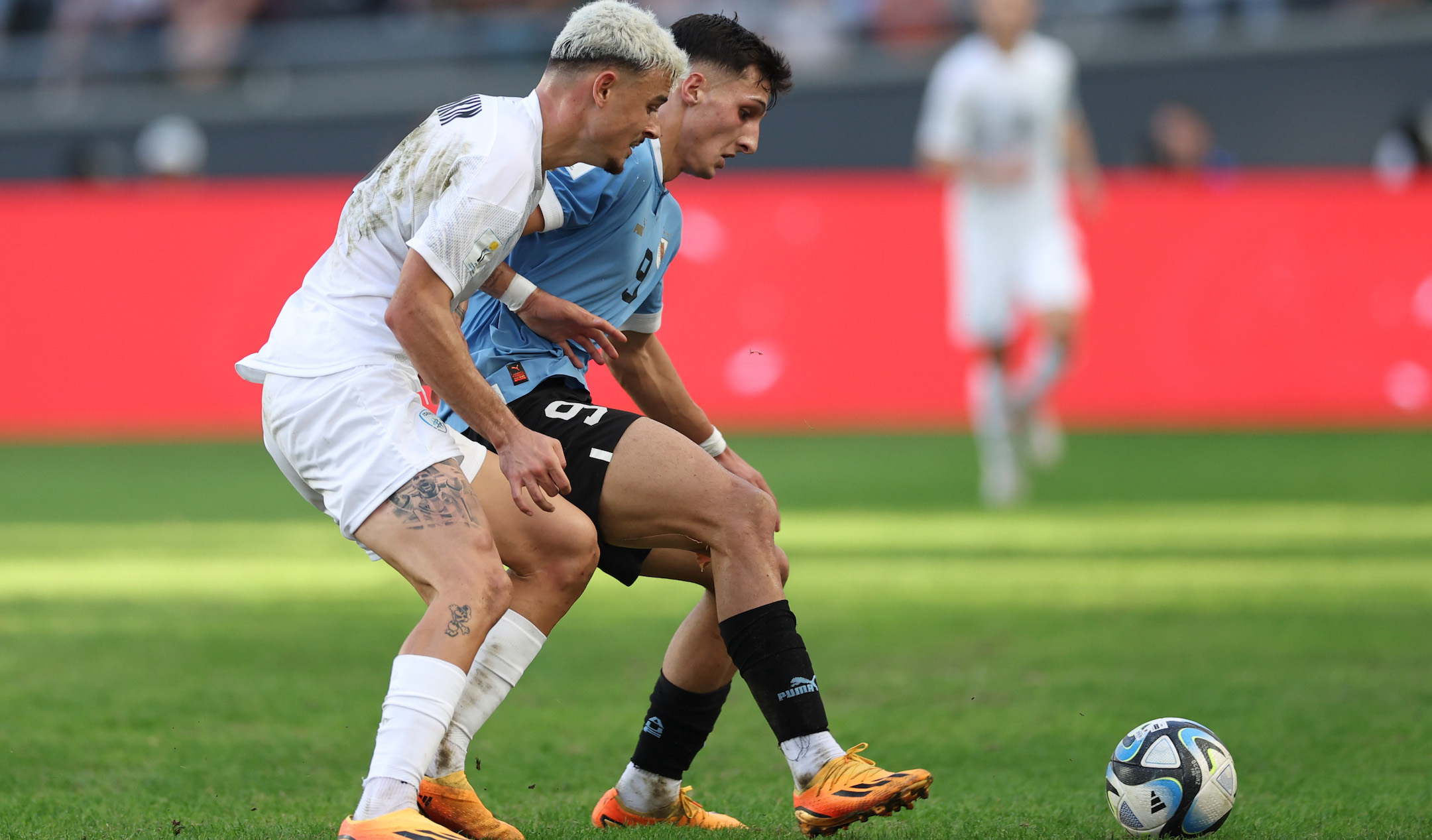Stav Lemkin of Israel, left, battles for the ball with Andres Ferrari of Uruguay during the FIFA U-20 World Cup semifinal at Estadio La Plata in La Plata, Argentina, June 8, 2023. (Tim Nwachukwu/FIFA via Getty Images)