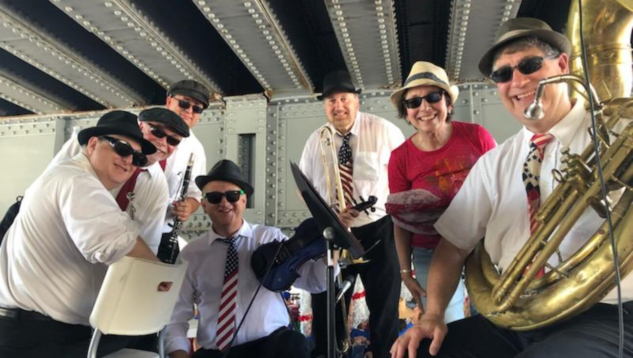 The Maxwell Street Klezmer band under a bridge at the Highland Park July 4 parade in 2019.