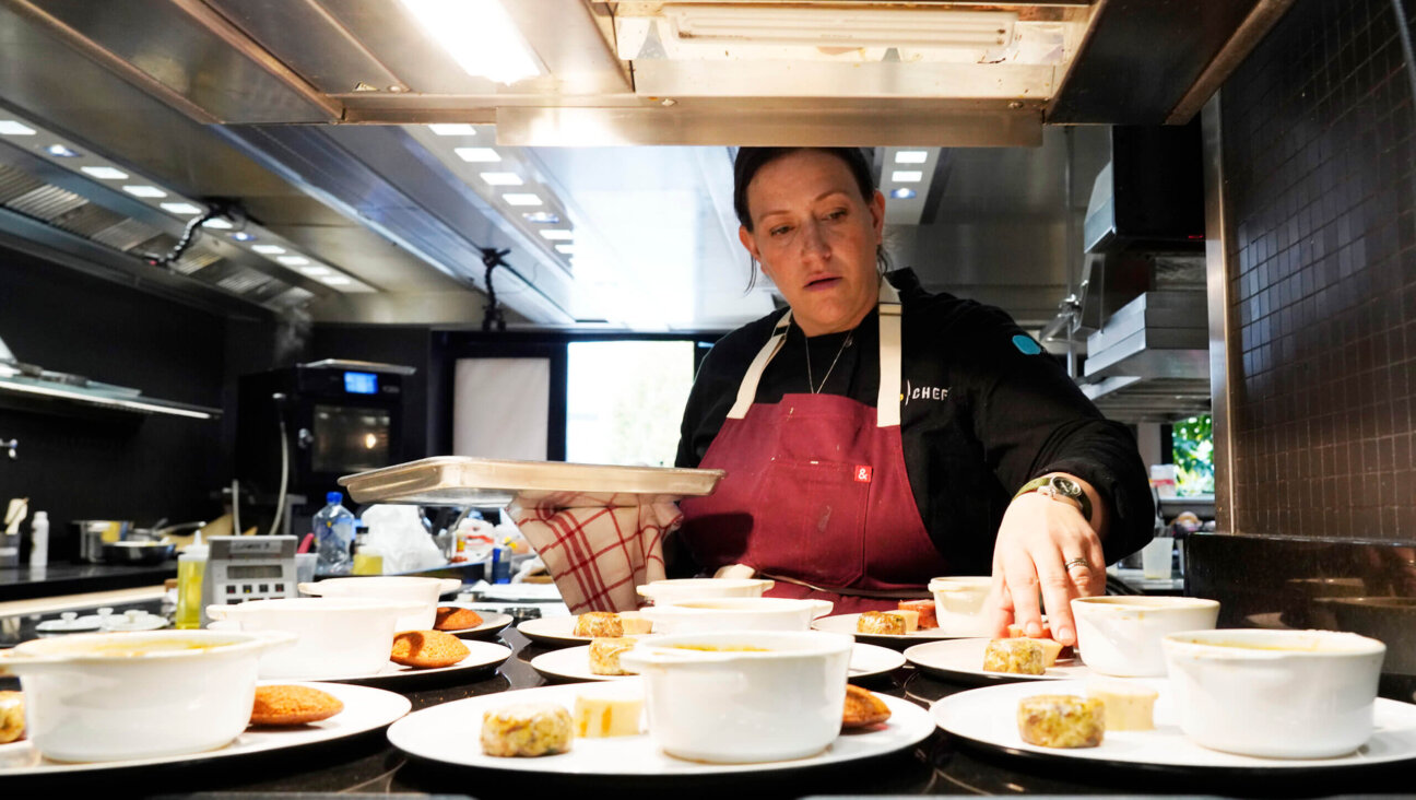 Sara Bradley plating burgoo with beans and cornbread on the finale of <i>Top Chef: World All-Stars</i>.