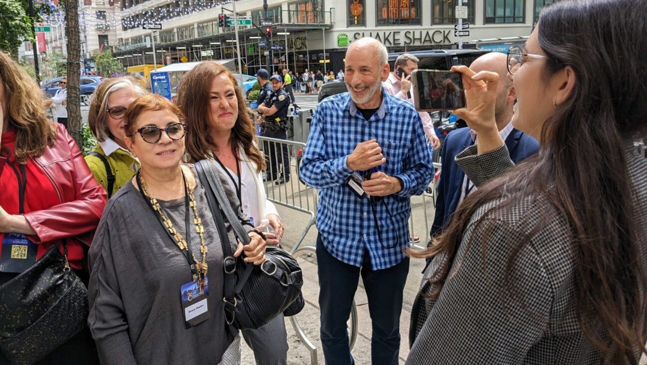 Anti-government protesters are filmed by UnXeptable activist Shany Granot-Lubaton after being ejected from the Jerusalem Post conference in New York City, June 5, 2023. (Ben Sales)