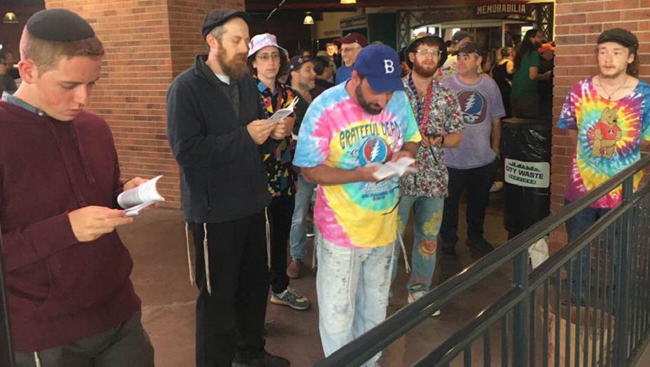 Rabbi David Kalb, center, leads a crowd of Jewish Deadheads in prayer at Citi Field's Jackie Robinson Rotunda on June 21, 2023. (Courtesy)