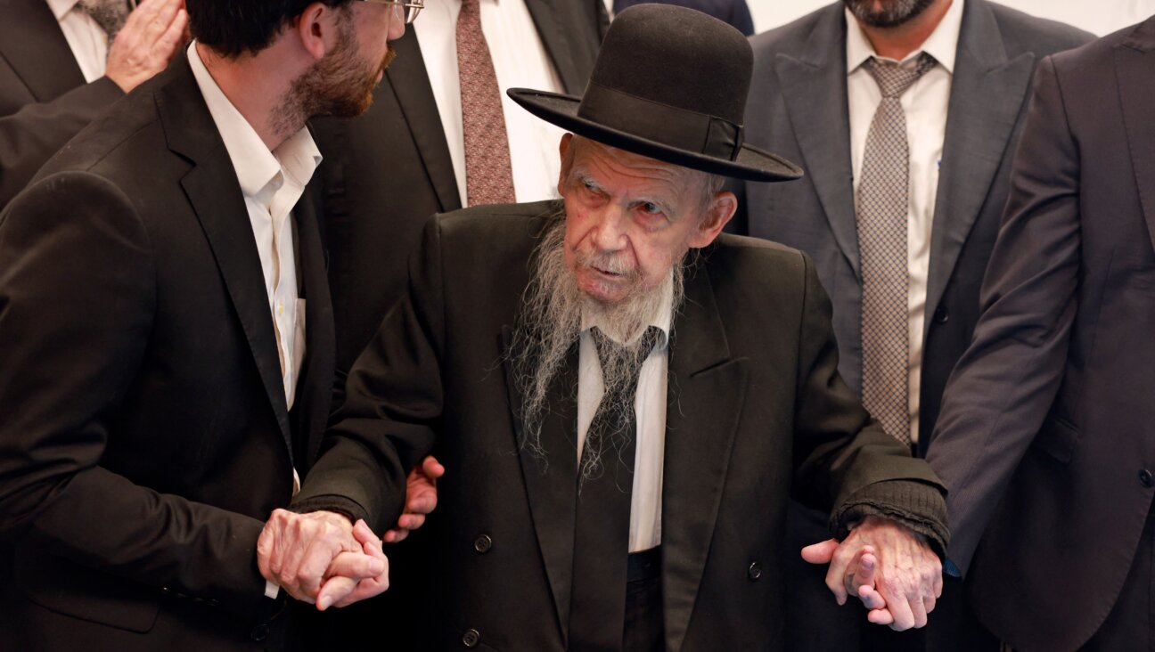 Israel's Rabbi Yerachmiel Gershon Edelstein (C) is helped to cast his ballot at a polling station in Bnei Brak, an Orthodox Jewish city near Tel Aviv, on November 1, 2022. - Israelis began voting in their fifth election in less than four years, with veteran leader Benjamin Netanyahu campaigning for a comeback alongside far-right allies. (Photo by Menahem KAHANA / AFP) (Photo by MENAHEM KAHANA/AFP via Getty Images)