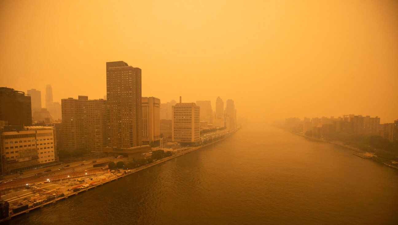 The tramway to Roosevelt Island crosses the East River as smoke from Canadian wildfires casts a haze over the area on June 7, 2023 in New York City. 