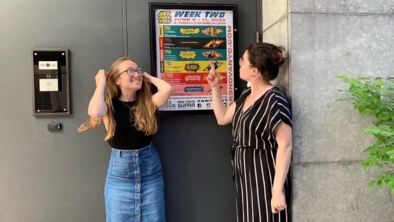 Derman, left, with friend Molly Rosa Houlahan, in front of a poster for one of Derman's plays.