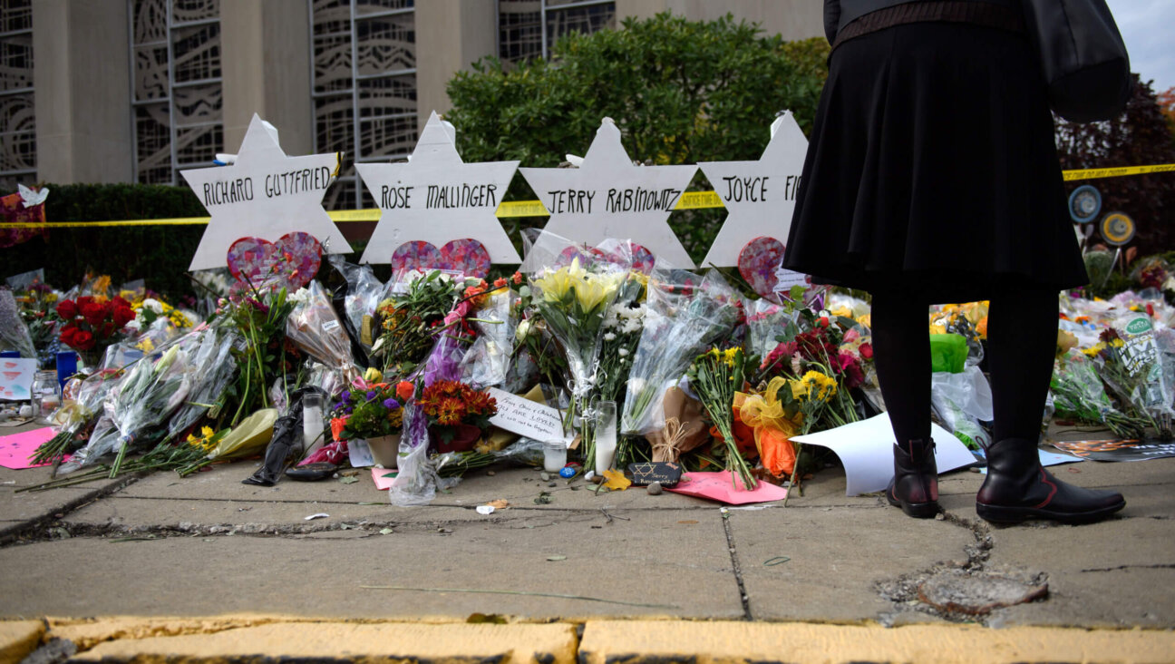 Mourners visit the memorial outside the Tree of Life Synagogue on October 31, 2018, in Pittsburgh, Pennsylvania, where eleven Jews were killed in a mass shooting.