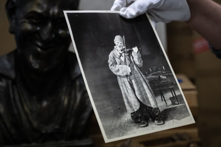 The director of a museum in Switzerland holds a picture of Grock the Clown. (Getty)