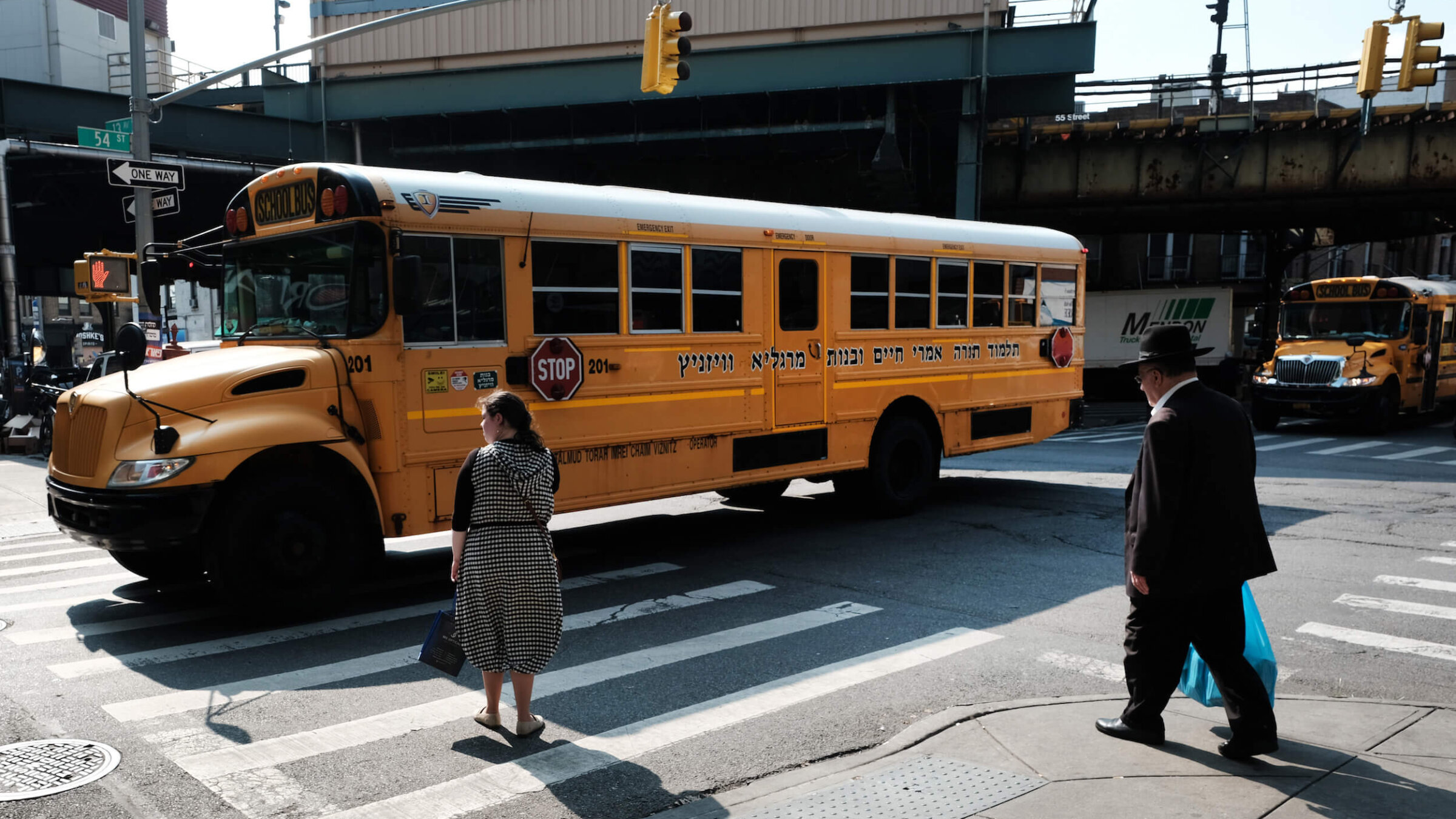 A yeshiva school bus drives through Brooklyn.