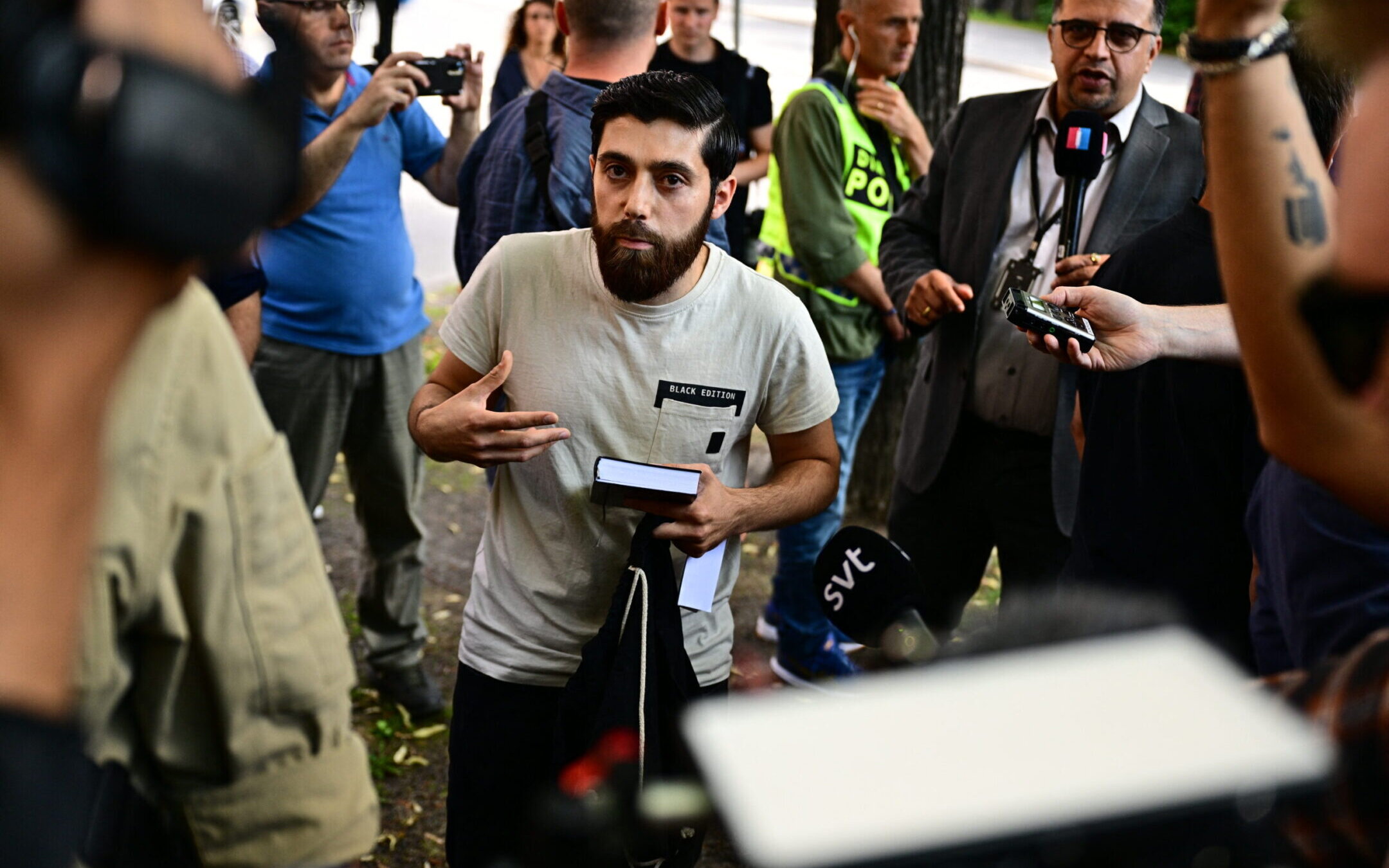 Ahmad Alush, who had been given permission by the police for a public gathering to burn a Jewish and Christian Bible outside the Israeli embassy in Stockholm, is surrounded by journalists, July 15, 2023. (Magnus Lejhall/TT News Agency/AFP via Getty Images)