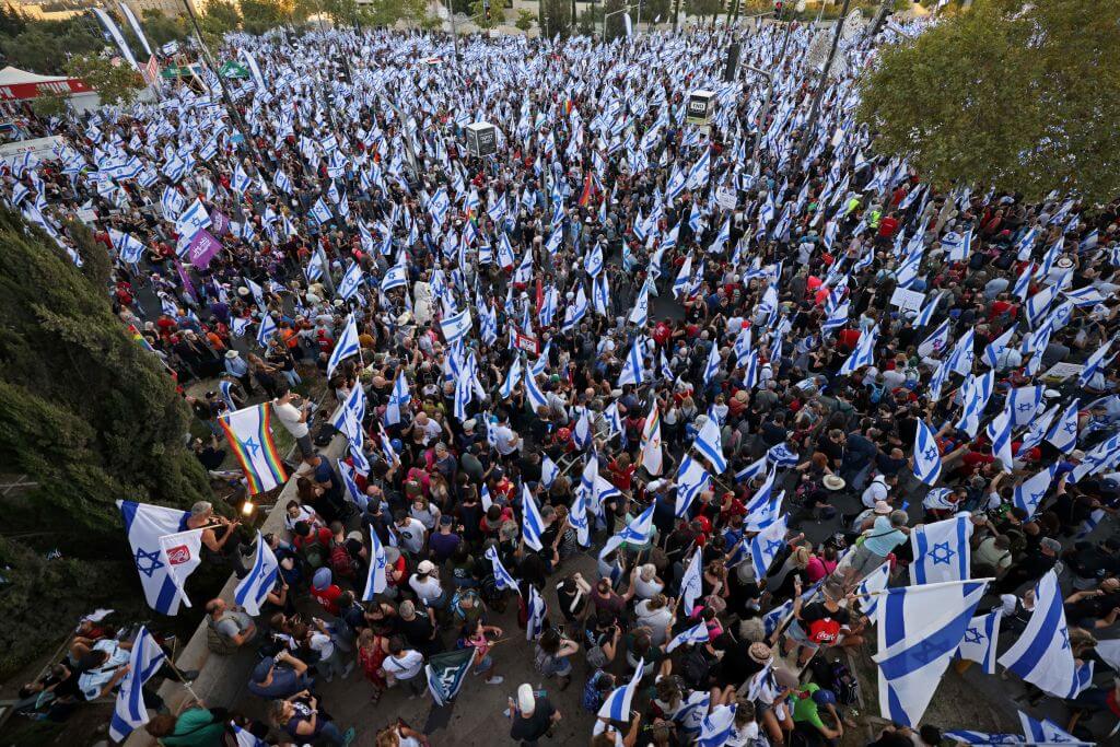 Demonstrators gather with national flags outside the Israeli parliament (Knesset) in Jerusalem on July 23, 2023, amid a months-long wave of protests against the government's planned judicial overhaul. 