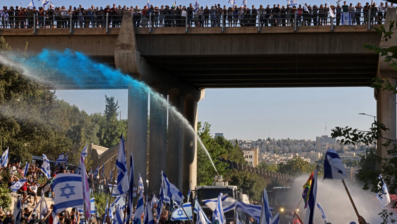 Israeli security forces use a water cannon to disperse demonstrators blocking the entrance of the Knesset, Israel's parliament, in Jerusalem on July 24, 2023.