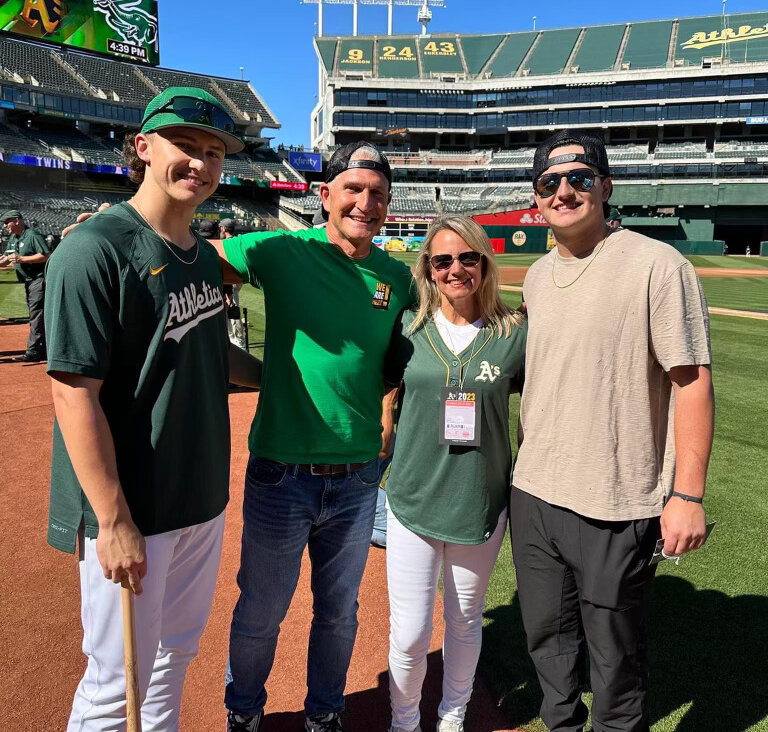 Empty nesters: Adam and Kelly Gelof, middle, with Zack Gelof, <i>left</i>, and Jake Gelof, <i>right</i>, at the Oakland Coliseum during Zack's debut series with the A's.