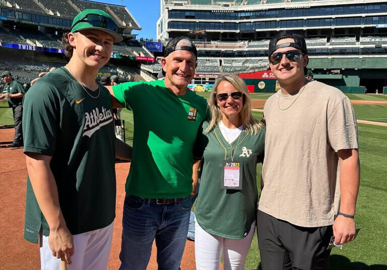 Empty nesters: Adam and Kelly Gelof, middle, with Zack Gelof, <i>left</i>, and Jake Gelof, <i>right</i>, at the Oakland Coliseum during Zack's debut series with the A's.