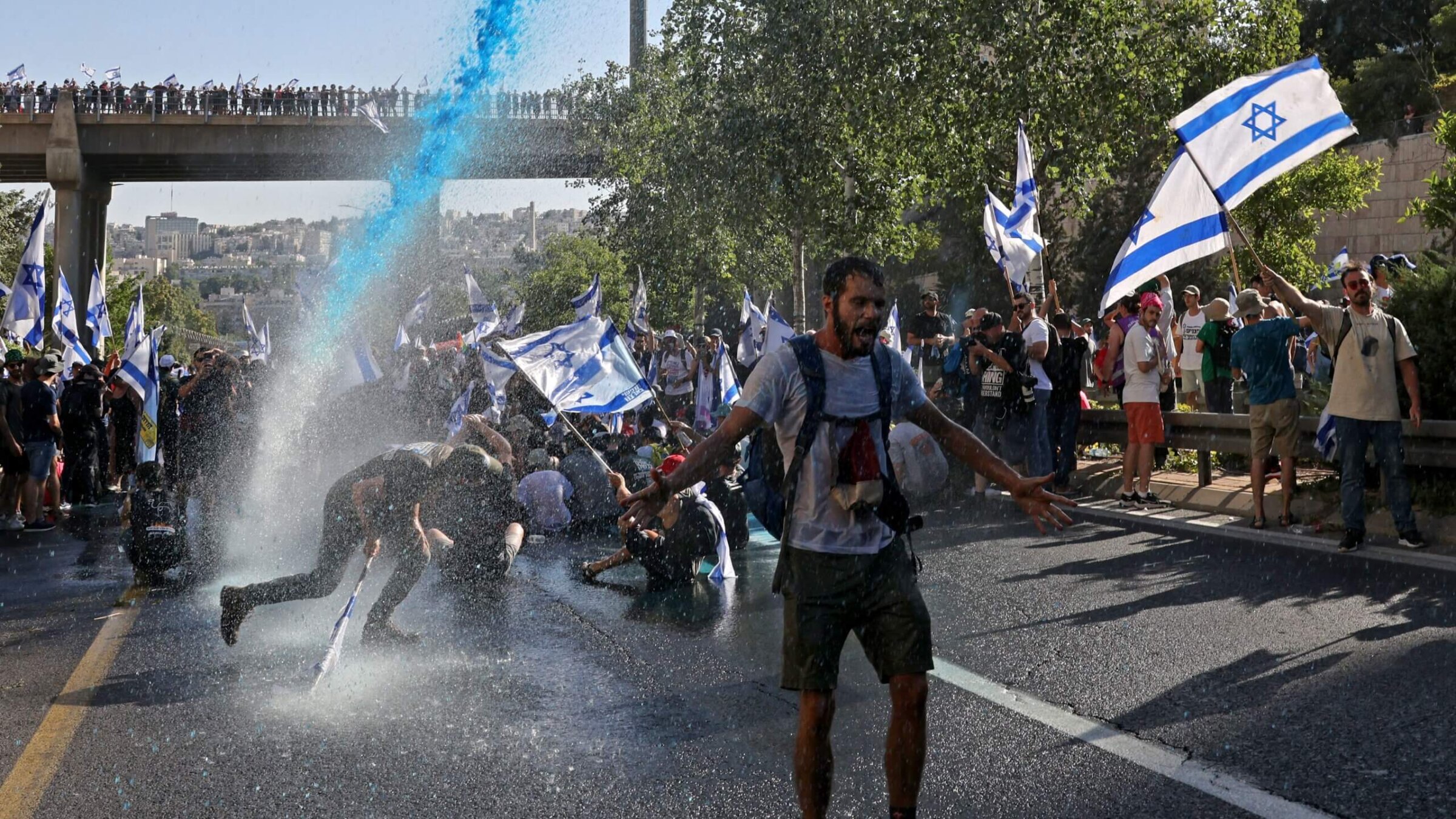 Israeli security forces use a water cannon to disperse demonstrators blocking the entrance of the Knesset, Israel's parliament, in Jerusalem on July 24, 2023, amid a months-long wave of protests against the government's planned judicial overhaul. Israel's hard-right government pushed through parliament a key clause of its controversial judicial reform package despite months of mass protests and concerns voiced by foreign allies. 