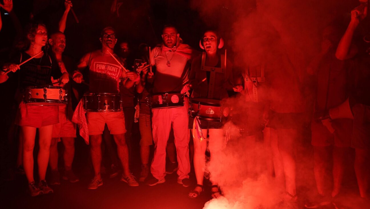 Protesters beat drums as they protest against the Israeli government's judicial overhaul plan in Tel Aviv on July 29, 2023. 