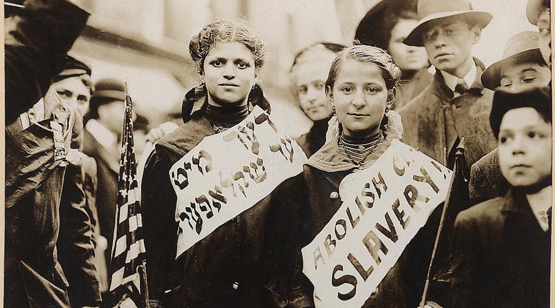 Two girls wear banners with the slogan “Abolish child slavery” in English and Yiddish, probably taken during May 1, 1909 labor parade in New York City. (Library of Congress Prints and Photographs Division)