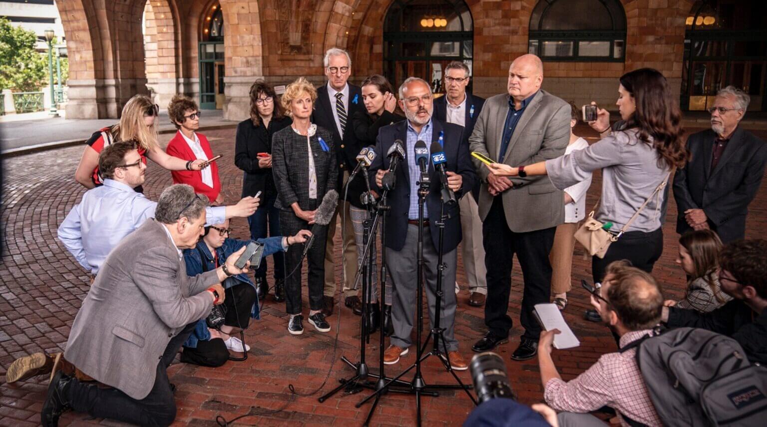 Pittsburgh Jewish Federation CEO Jeff Finkelstein speaks to the press after a jury find the gunman who shot 11 Jewish worshipers guilty of federal crimes. The writer kneels at lower left, in Pittsburgh, June 16, 2023.
