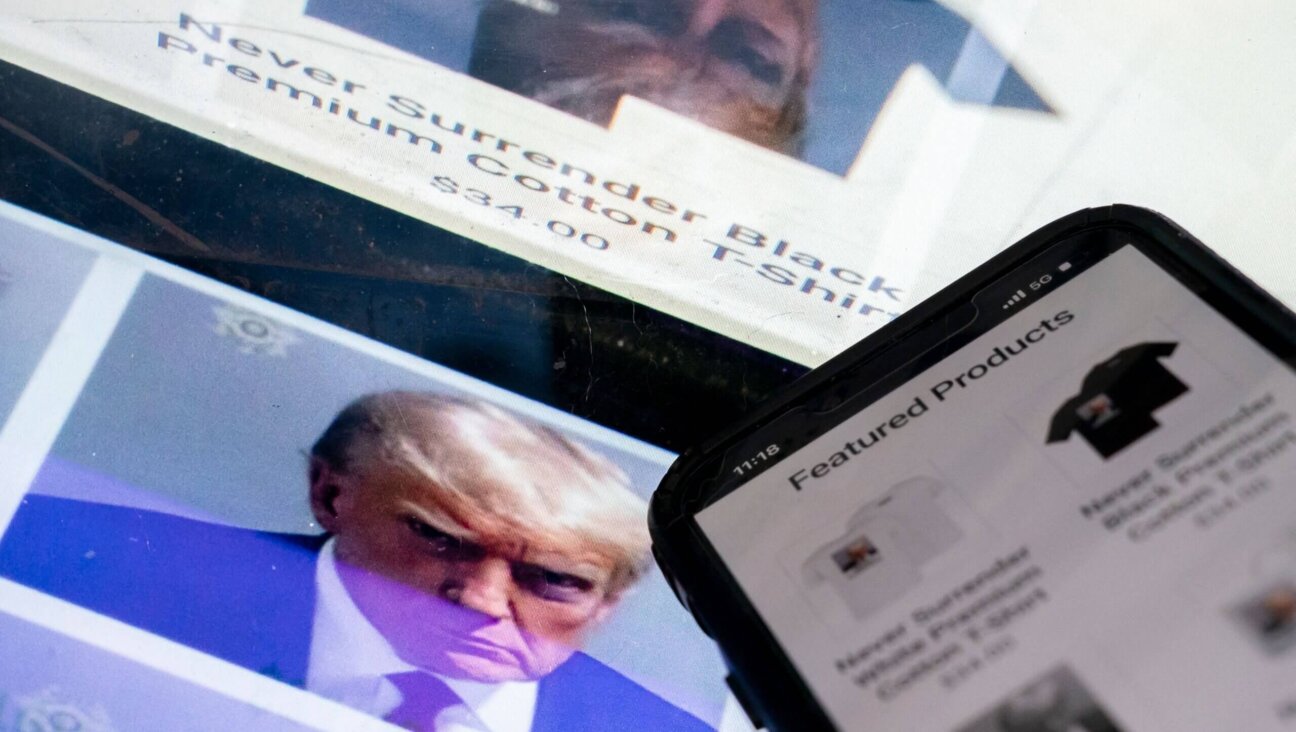 A photo illustration shows the mug shot of former U.S. President Donald Trump next to a website called Trump Save America JFC, a joint fundraising committee on behalf of Donald J. Trump for President 2024, which is selling merchandise bearing his mug shot.