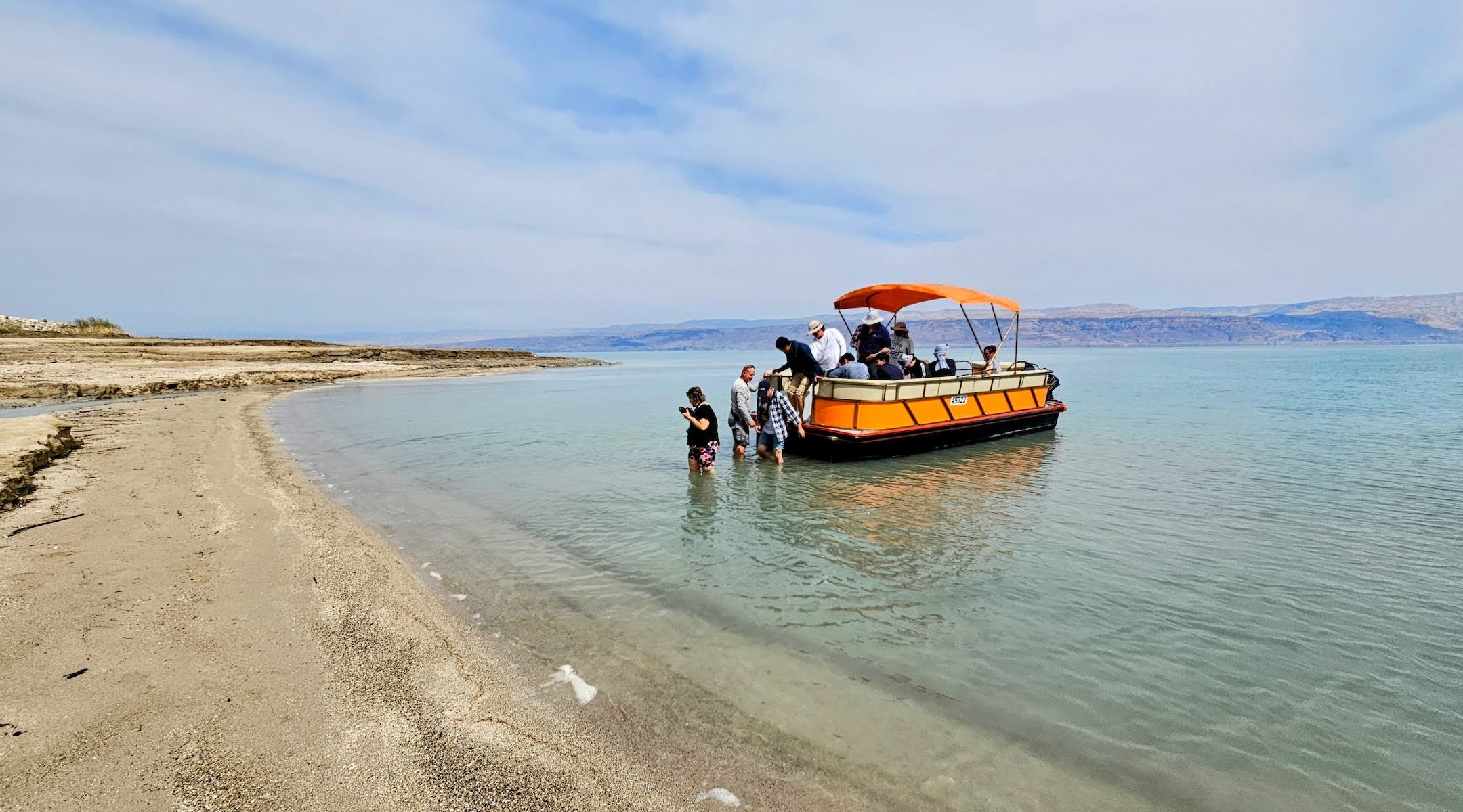 Passengers wade into the waters of the Dead Sea from Noam Bedein’s boat on a recent excursion. (Noam Bedein)