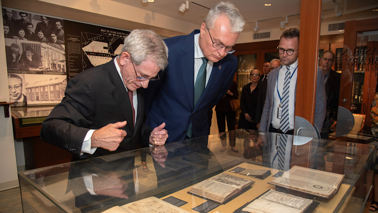 Jonathan Brent, executive director and CEO of YIVO, and Gitanas Nausėda, president of Lithuania, examine holdings in the Strashun Rare Books Room at YIVO’s New York headquarters, Sept. 18, 2023. The room is named for a Jewish scholar in Vilna (now Vilnius) who collected nearly 7,000 volumes of Yiddish and other books before his death in 1885. (YIVO/ Melanie Einzig)