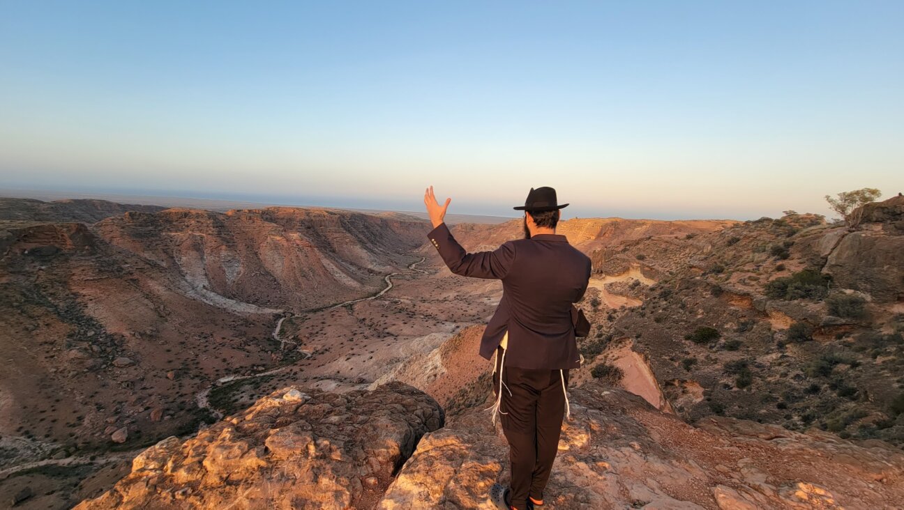 Rabbi Mendel Junik prays while overlooking the rugged outback of the Pilbara region in western Australia. (Courtesy of Rabbi Menachem Aron)