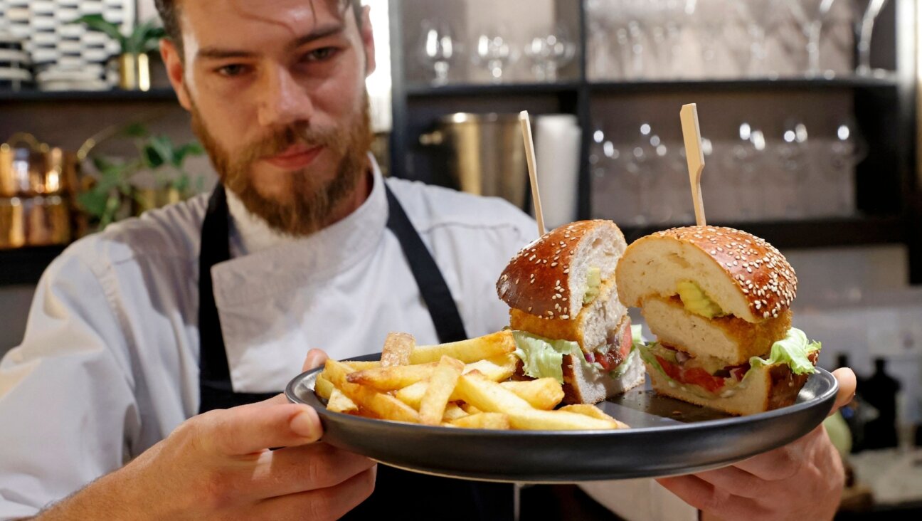 Israeli chef Shachar Yogev serves a burger made with “cultured chicken” meat at The Chicken, SuperMeat’s restaurant adjacent to their production site in the Israeli town of Ness Ziona on June 18, 2021. (Photo by JACK GUEZ/AFP via Getty Images)