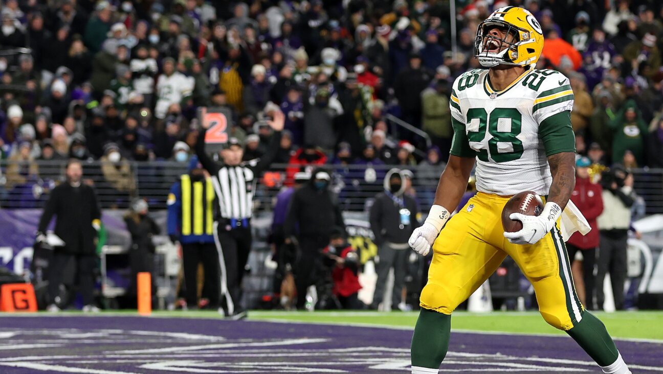 Running back A.J. Dillon of the Green Bay Packers celebrates after rushing for a first half touchdown against the Baltimore Ravens at M&T Bank Stadium in Baltimore, Dec. 19, 2021. (Rob Carr/Getty Images)