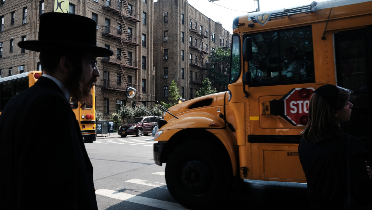 A yeshiva school bus drives through Borough Park in Brooklyn on September 12, 2022.