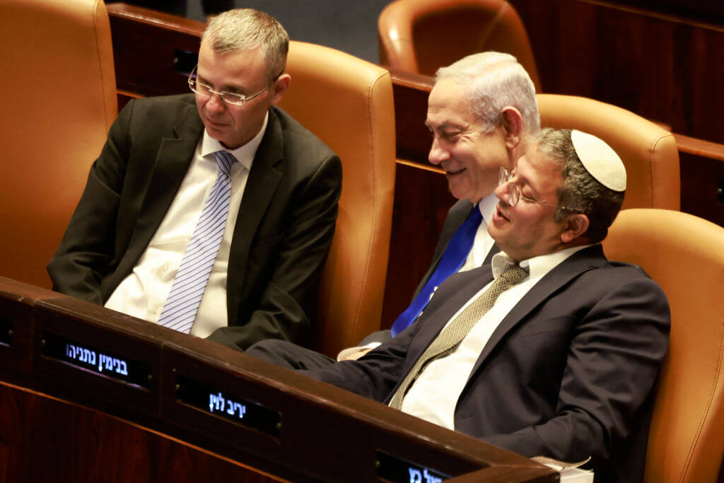 Israel's prime minister, Benjamin Netanyahu, <i>center</i>, speaks with National Security Minister Itamar Ben-Gvir, <i>right</i>, and Justice Minister Yariv Levin, <i>left</i>, during a Knesset meeting in 2023.