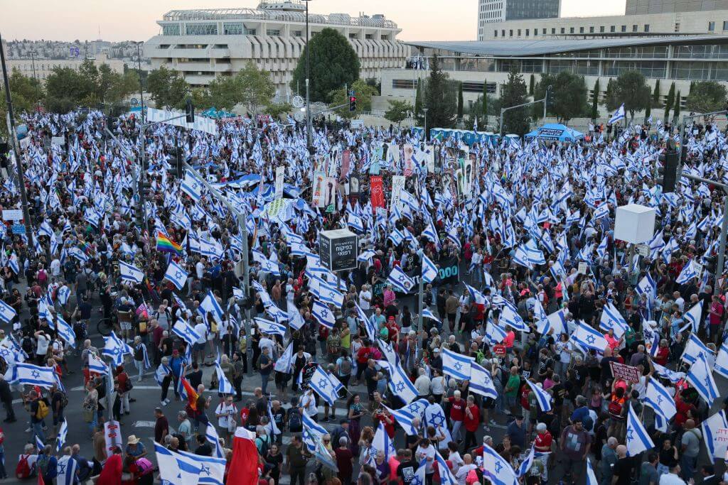 People attend a protest outside the Supreme Court in Jerusalem against the Israeli government's judicial overhaul plan on September 11, 2023. 