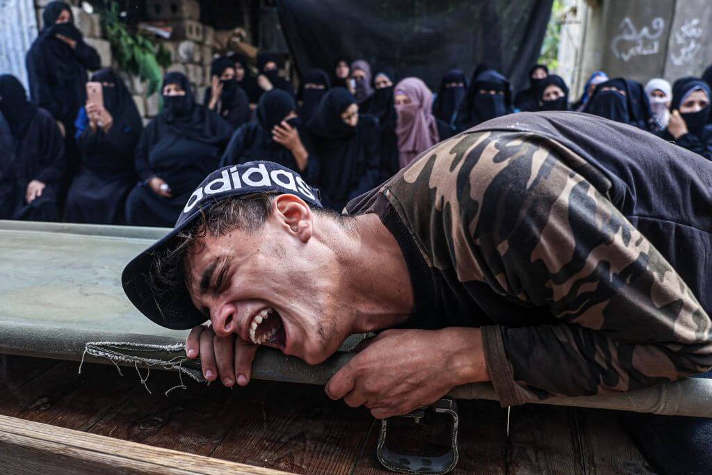 A friend of 25-year-old Palestinian Yousef Radwan, who was killed the previous day amid clashes, cries during his funeral on September 20, 2023.