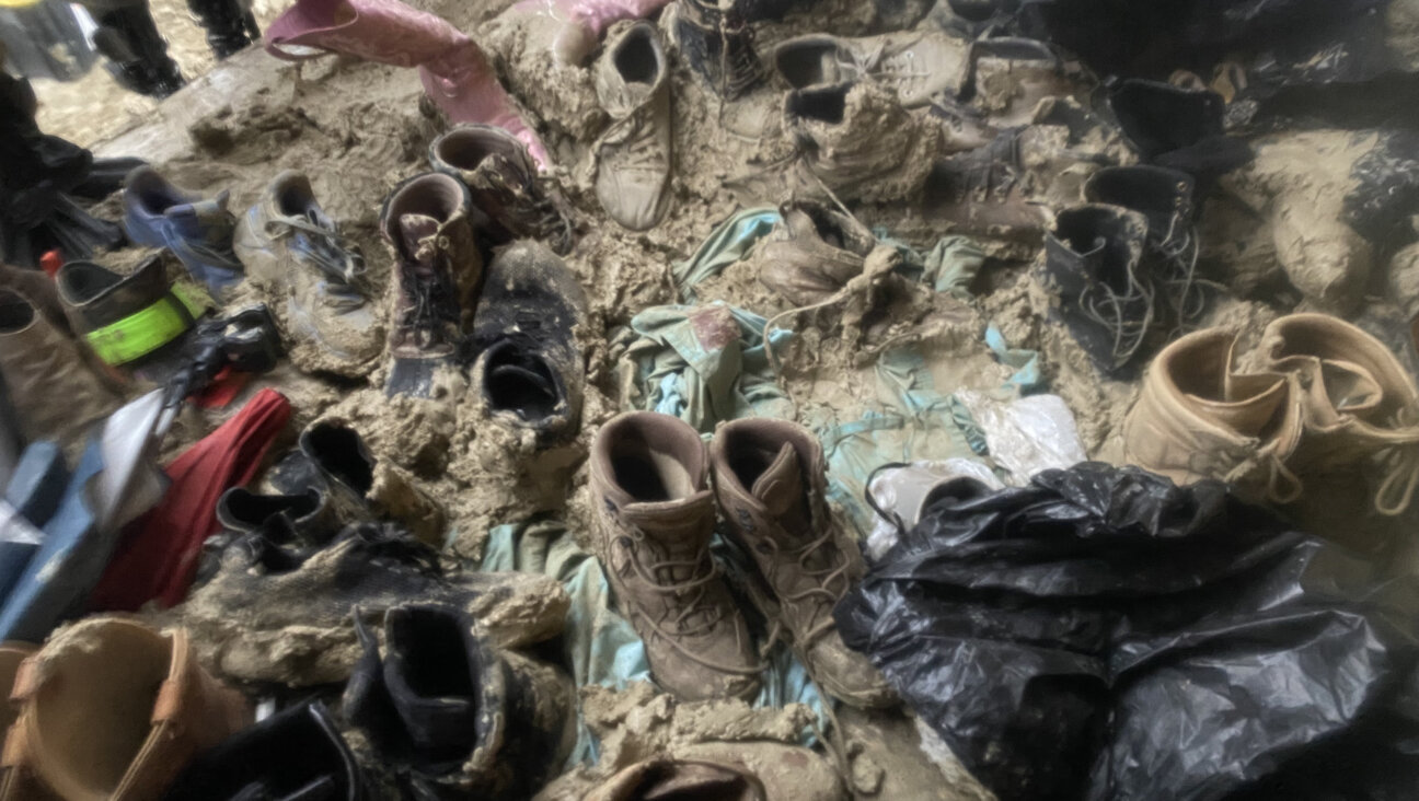 Shoes piled up in the mud outside the shipping container where the Burning Man Shabbat service was held.