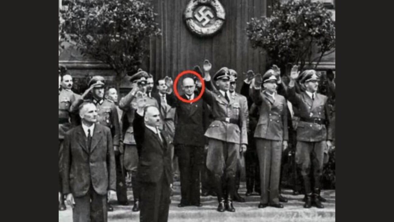 Volodymyr Kubijovych, circled, gives a Nazi salute at an SS Galichina recruitment ceremony in 1943. An endowment at the University of Alberta honors Kubijovych.