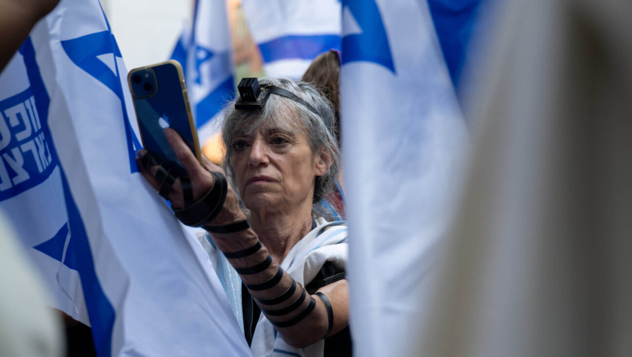 A protestor wears tefillin during the service portion of a Praying for Israeli Democracy rally on the Jewish holiday of Tisha B’ Av outside the Israeli Consulate in New York on July 27, 2023 in New York City. 
