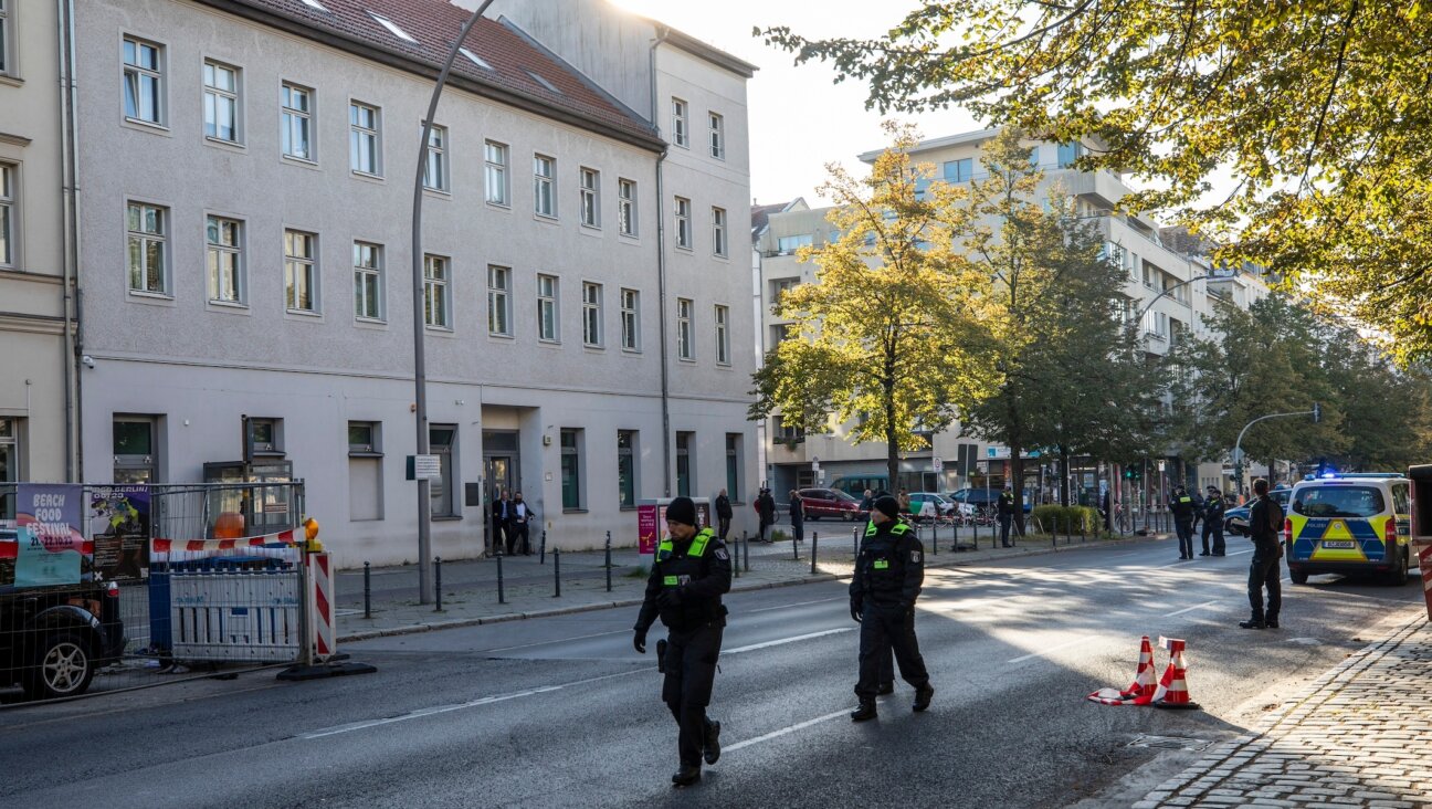 Police walk outside a building that houses a synagogue and school of the Kahal Adass Jisroel Jewish community in Berlin, Oct. 18, 2023. (Maja Hitij/Getty Images)