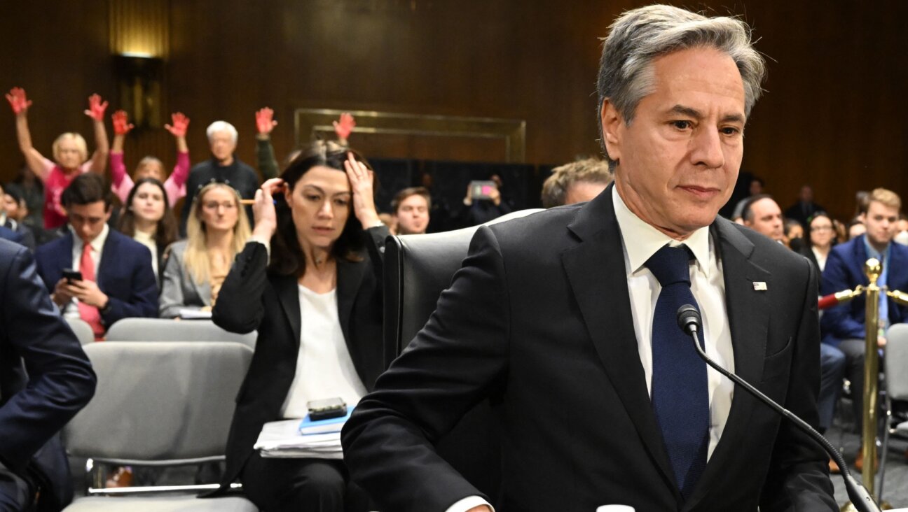 U.S. Secretary of State Antony Blinken looks on as protestors hold their hands in the air during a Senate Appropriations Committee hearing to examine the national security supplemental request, on Capitol Hill, Oct. 31, 2023. (Saul Loeb/AFP via Getty Images)