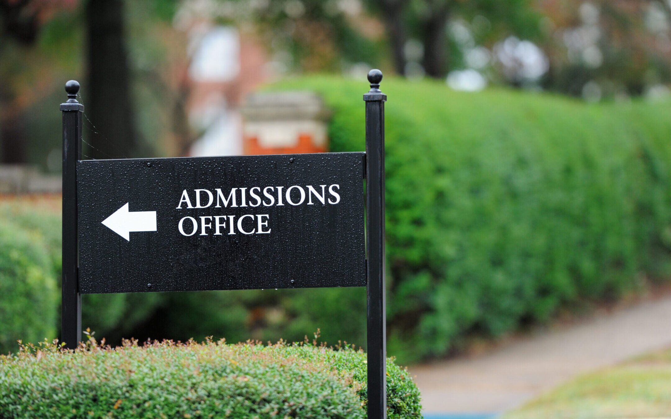 Close up of admissions office sign near a university campus. (Getty Images)