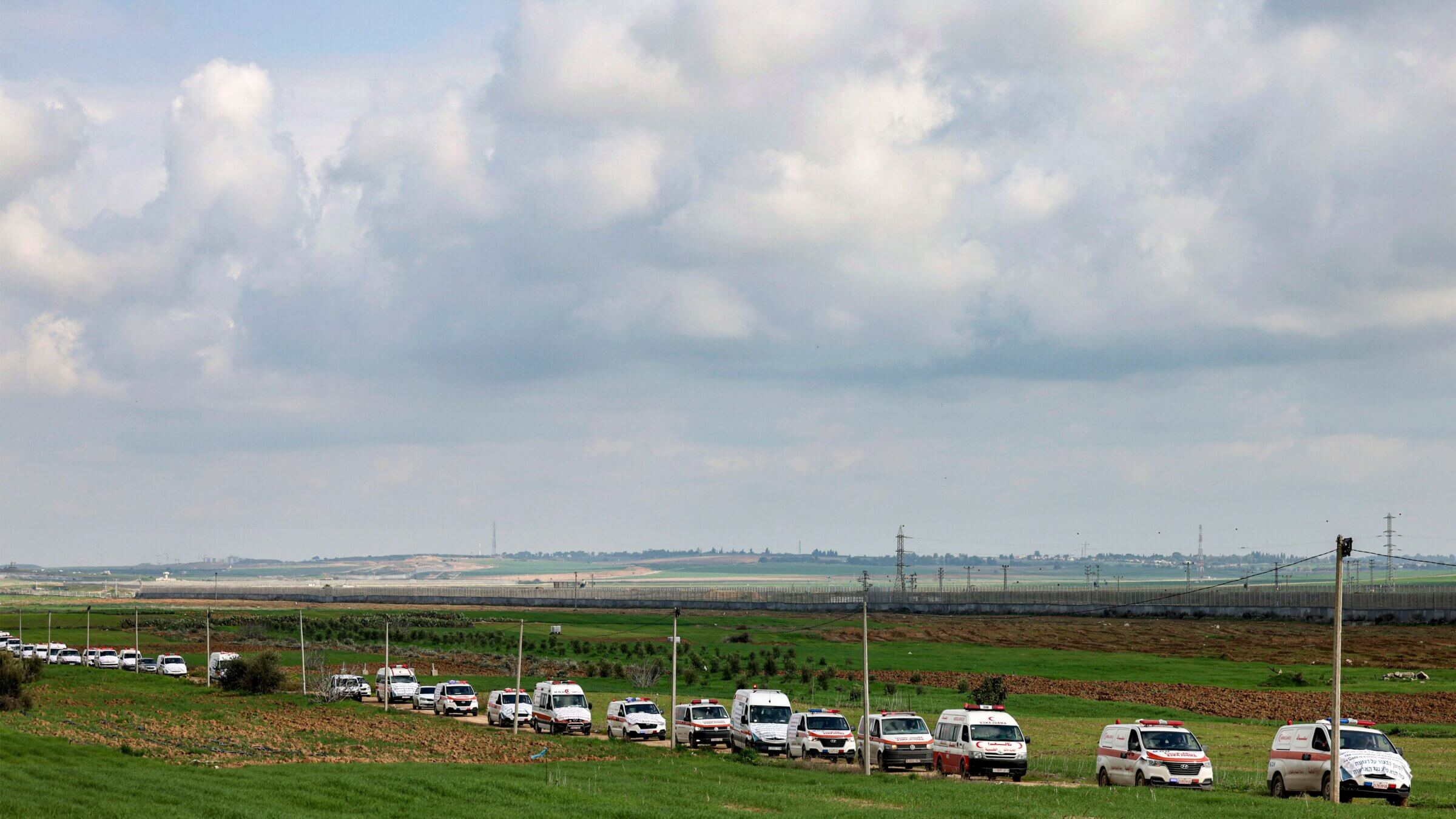 A convoy of ambulances moves along the border fence between Israel and Gaza. January, 2023.