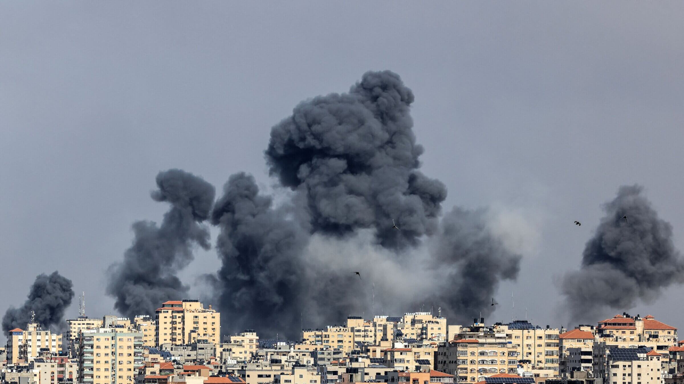 Smoke rises over Gaza City on Oct. 7, 2023 during Israeli air strike. Palestinian militants have begun a "war" against Israel, the country's defense minister said on October 7