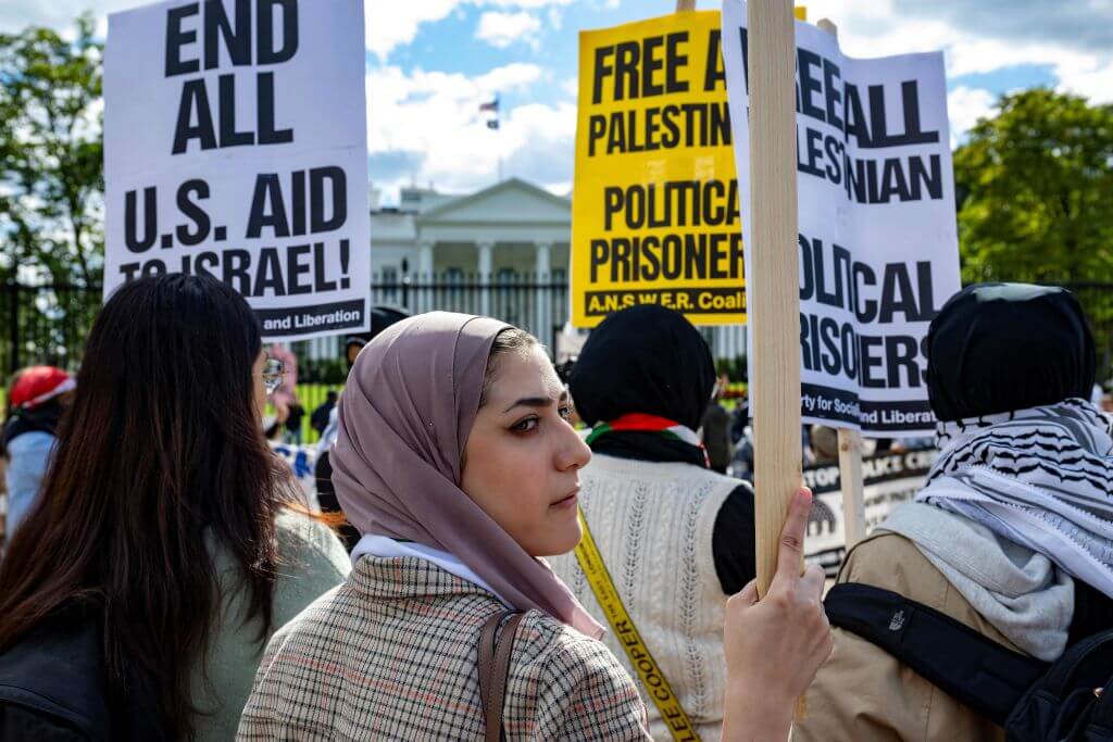 Demonstrators stand with placards outside the White House in Washington, DC, on October 8, 2023 as crowds rally in support of Palestinians after the Palestinian militant group Hamas launched an assault on Israel.