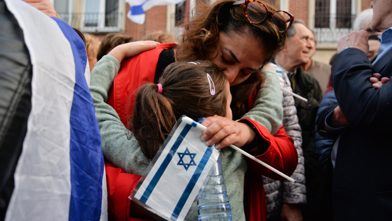  A woman hugs a child during the gathering in support of Israel in front of Israel's embassy in Brussels, Belgium.
