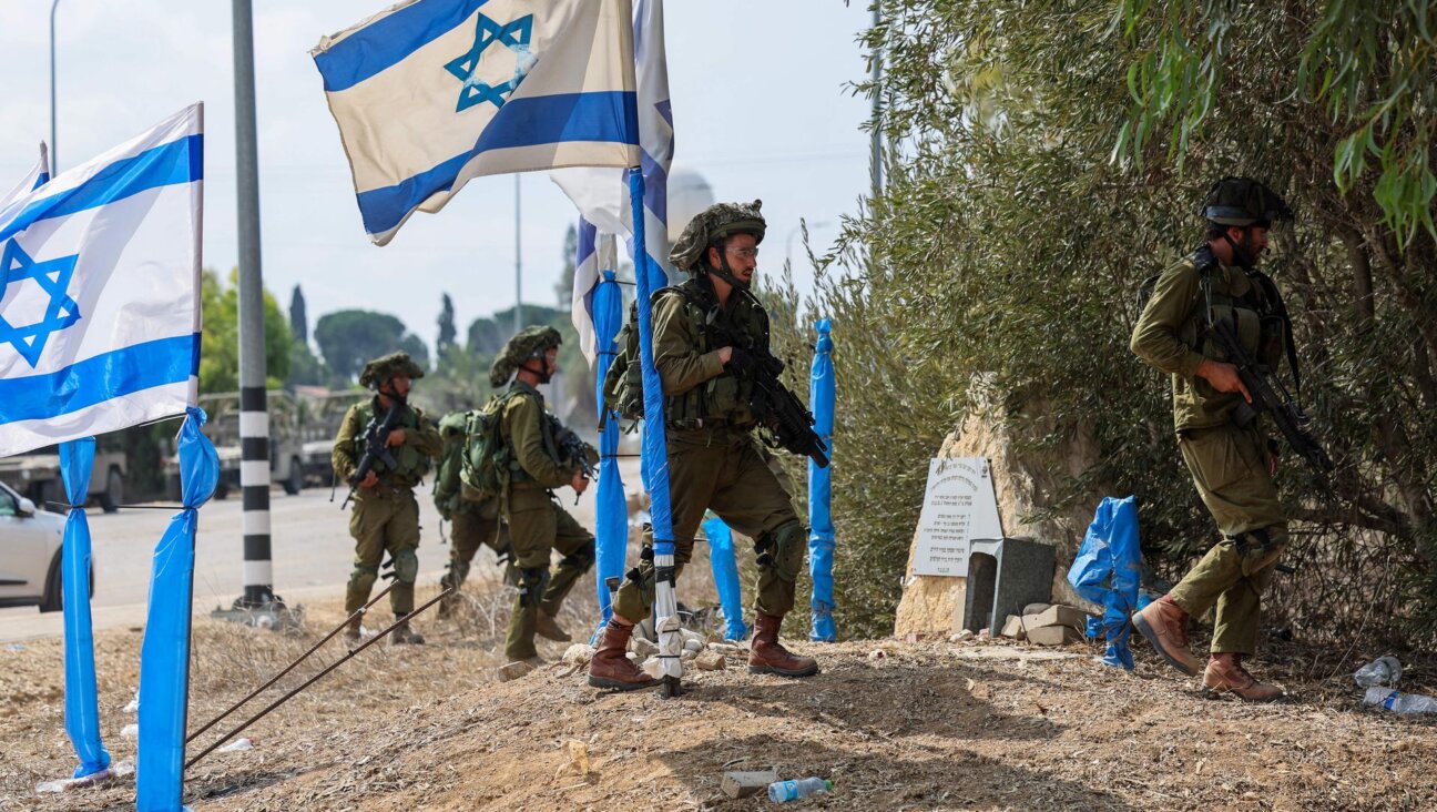 Israeli soldiers patrolled an area in Kfar Aza, which borders the Gaza Strip, on Tuesday. (JACK GUEZ/AFP via Getty Images)