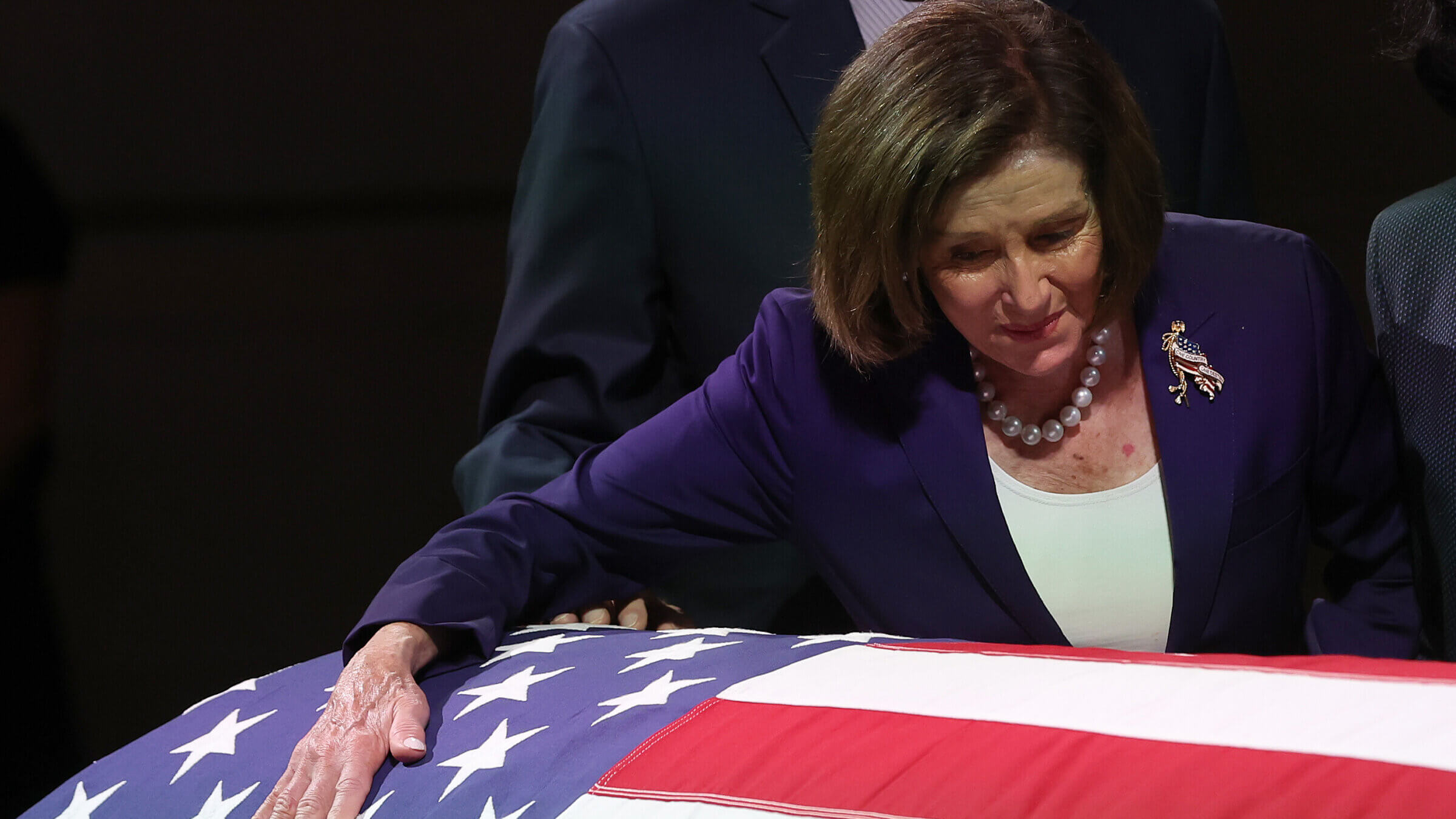 U.S. Rep. Nancy Pelosi (D-CA) leans on the casket of Sen. Dianne Feinstein (D-CA) as she lies in state at San Francisco City Hall on Oct. 4, 2023. 