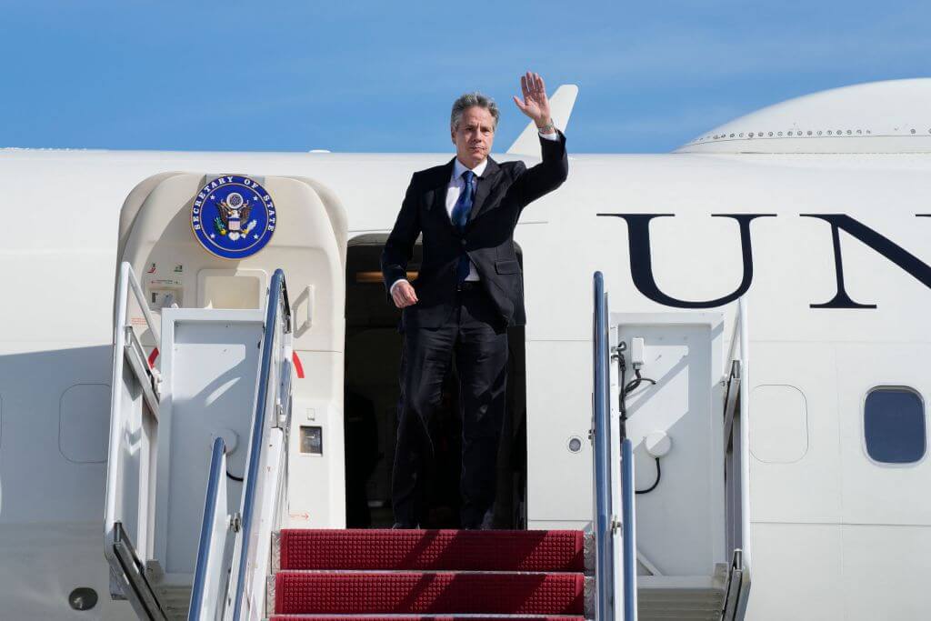 US Secretary of State Antony Blinken waves as he boards a plane, October 11, 2023, at Joint Base Andrews, Maryland, en route to Israel.