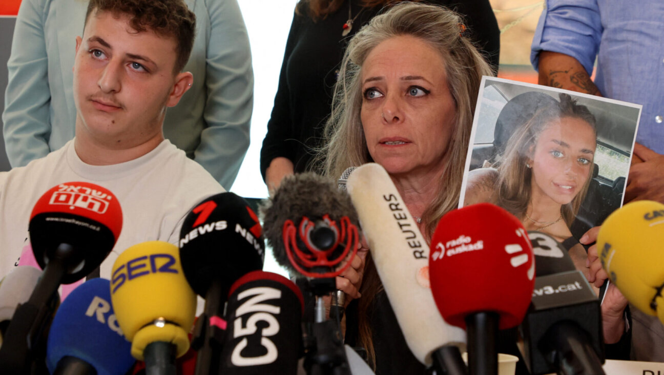Keren Shem, the mother of French-Israeli woman Mia Shem who is held hostage by Hamas in Gaza, holds a photograph of her daughter as she speaks to the press in Tel Aviv, Oct. 17, 2023. (Gil Cohen Magen/AFP via Getty Images)