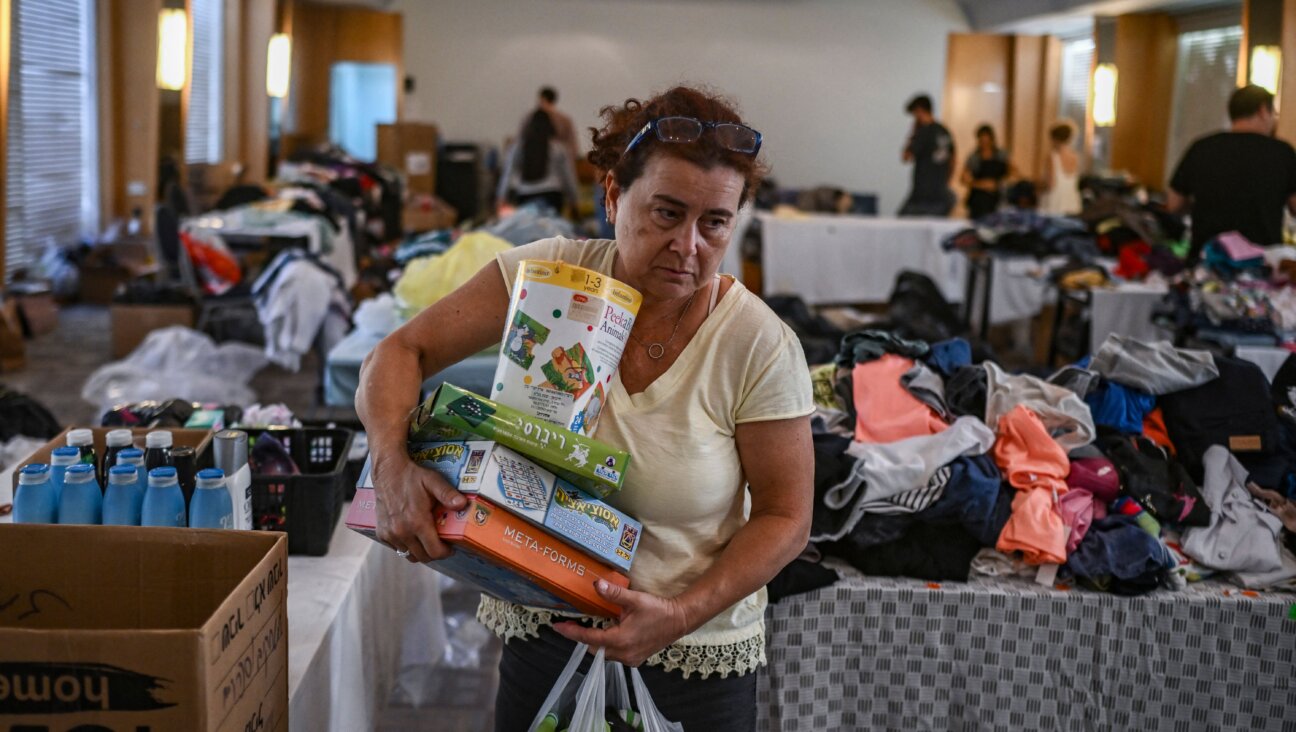 A woman carries donated toys at a hotel in the southern Israeli city of Eilat, which is hosting survivors from the Nir Oz kibbutz near the Gaza border that was attacked by Hamas militants on Oct. 7. Many American Jews have rushed to send donations to the region, sometimes grappling with how to balance helping Israeli and Palestinian victims. 