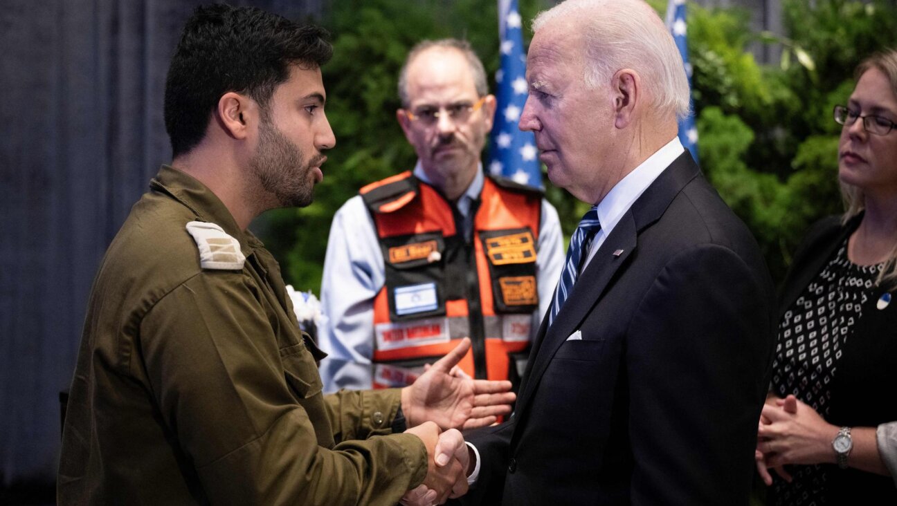 President Biden speaks with IDF Capt. Maor Farid while meeting Israelis affected by the war in Tel Aviv on Wednesday. (BRENDAN SMIALOWSKI/AFP via Getty Images)