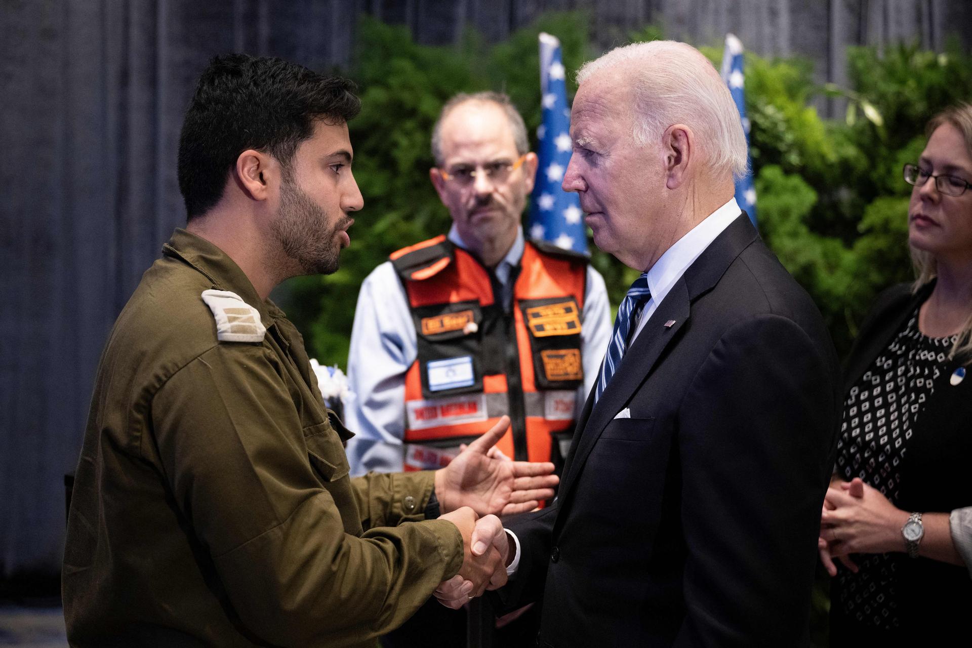 President Biden speaks with IDF Capt. Maor Farid while meeting Israelis affected by the war in Tel Aviv on Wednesday. (BRENDAN SMIALOWSKI/AFP via Getty Images)